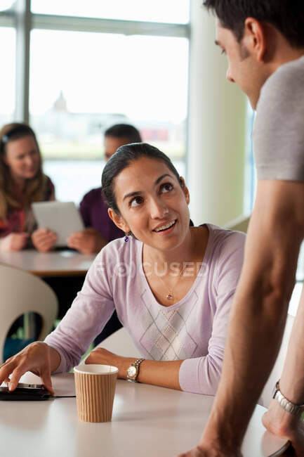 Man and woman having conversation in cafe — Stock Photo