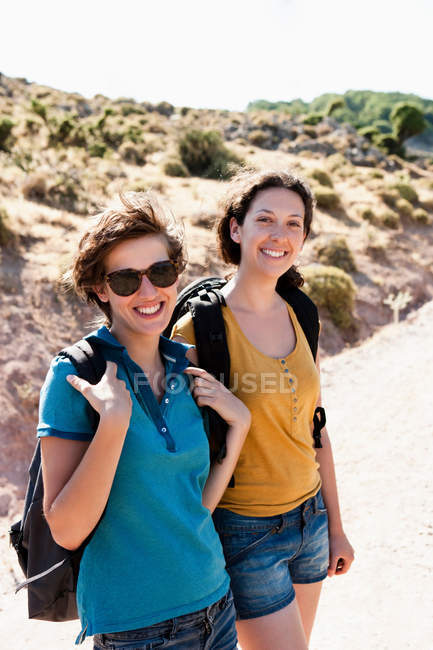 Women hiking together on hill, focus on foreground — Stock Photo