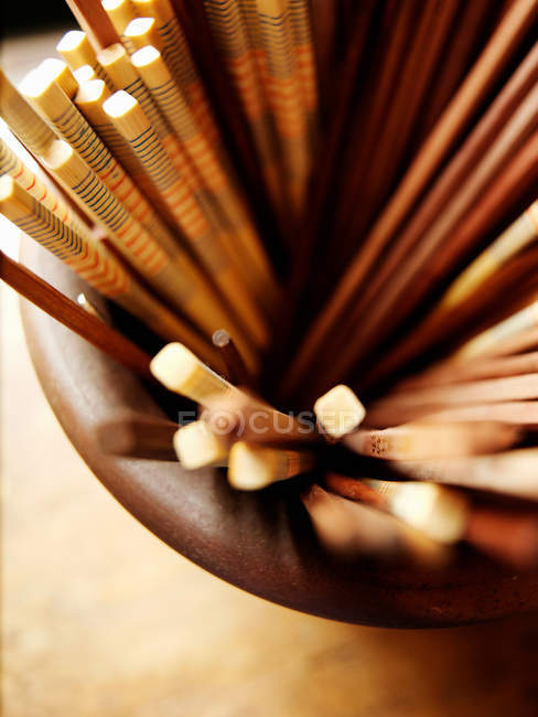 Close up shot of chopsticks in bowl, top view — Stock Photo