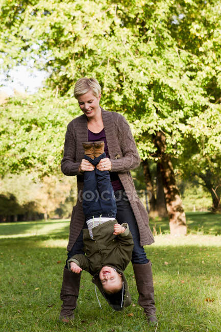 Madre e hijo jugando en el parque - foto de stock