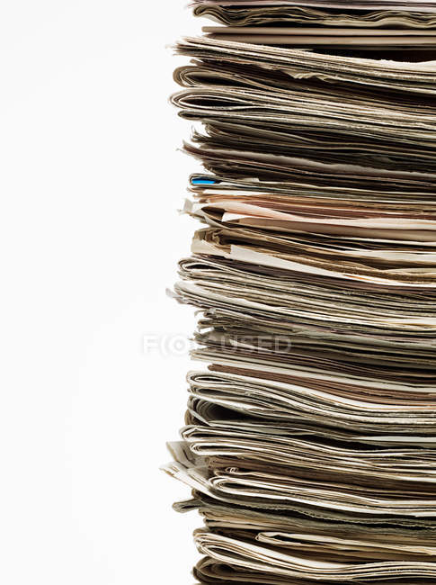 Stack of newspapers isolated on white background — Stock Photo