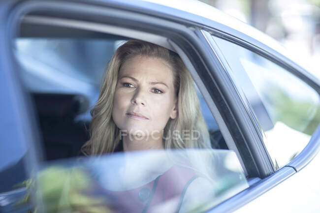Cape Town, South Africa, woman in back of car riding in city streets — Stock Photo