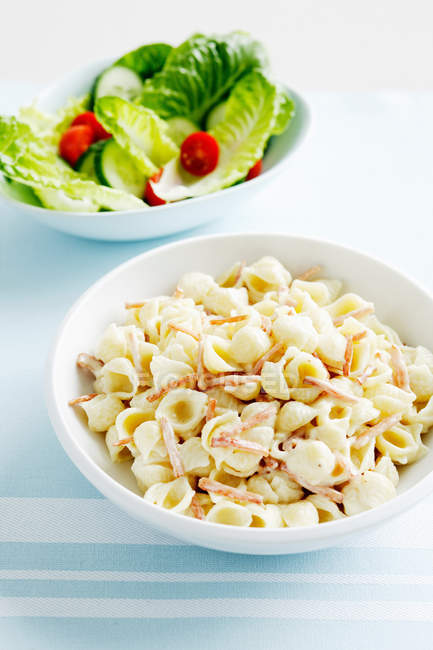 Pasta and salad in bowls — Stock Photo