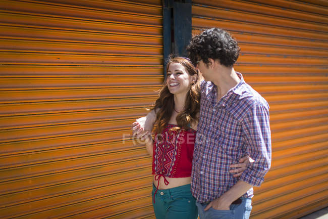 Romantic couple strolling with arms around each other — Stock Photo