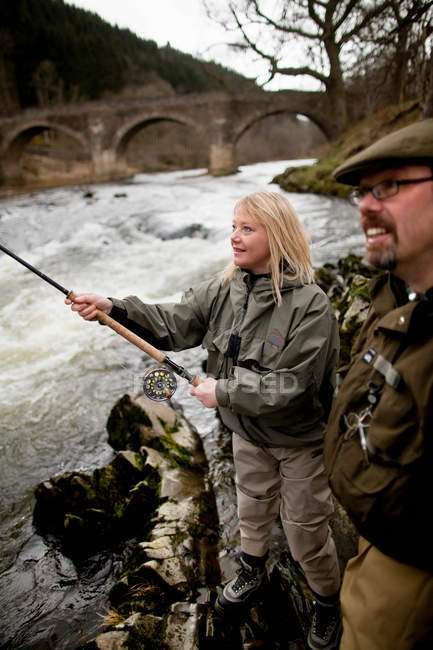 Couple fishing for salmon in river — Stock Photo