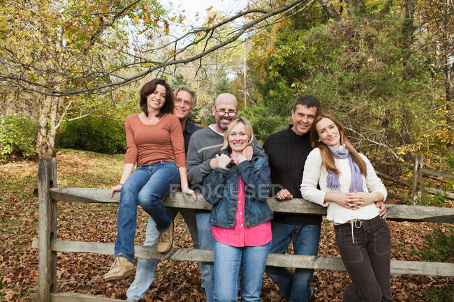 Mature friends around a fence — Stock Photo