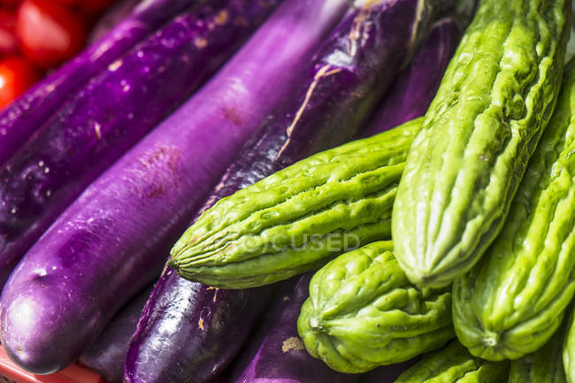 Close up of colored aubergines and bitter gourds — Stock Photo