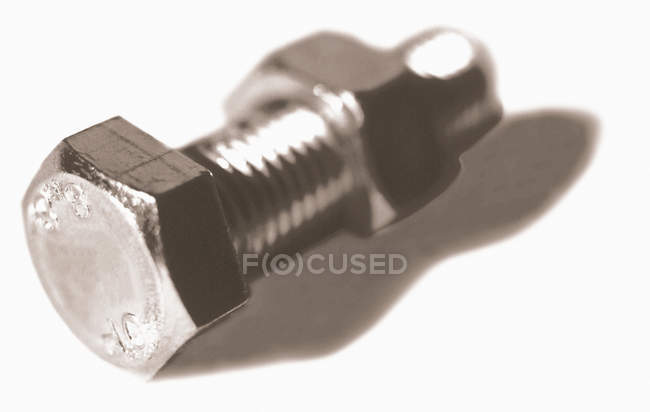 Close up of Nut and bolt on white surface — Stock Photo