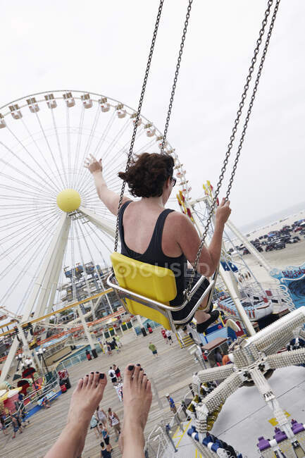 Mulher acenando de oscilações parque de diversões — Fotografia de Stock