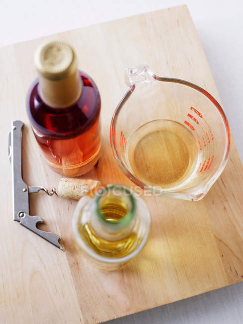 Wine bottle and corkscrew — Stock Photo