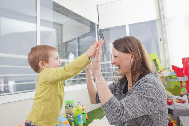 Mother playing with son at home — Stock Photo