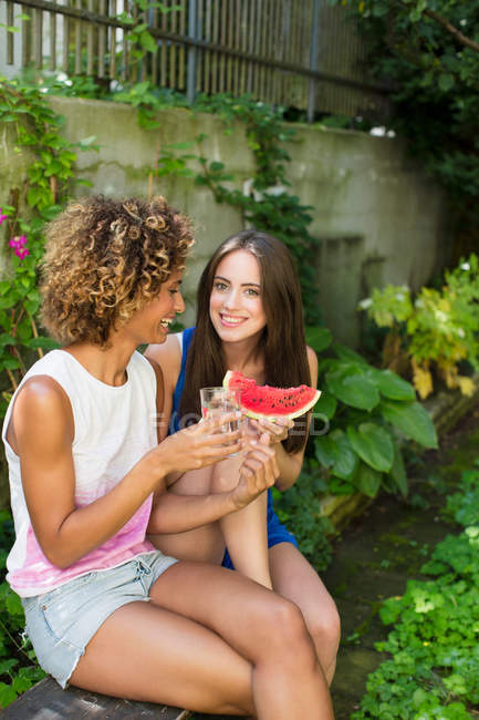 Smiling women eating watermelon — Stock Photo