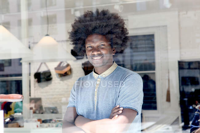 Mature man smiling with arms folded — Stock Photo