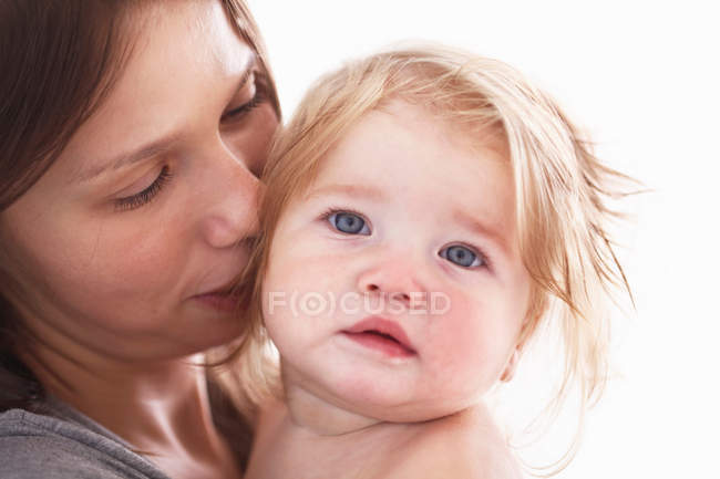 Primer plano de la madre sosteniendo hija - foto de stock