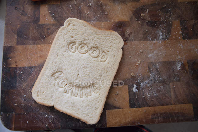 Good morning text stamped into bread — Stock Photo