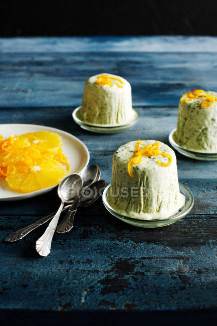 Plates of herb ice cream with orange — Stock Photo