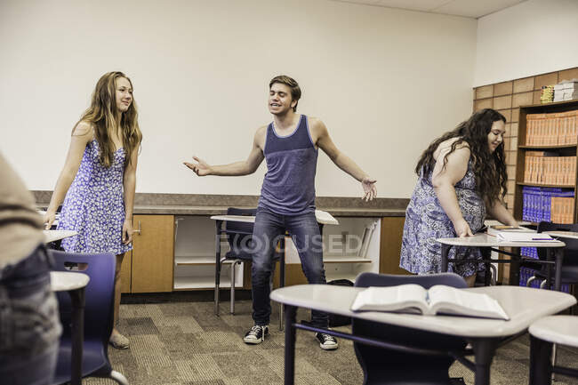 Teenage boy dancing in high school classroom — Stock Photo