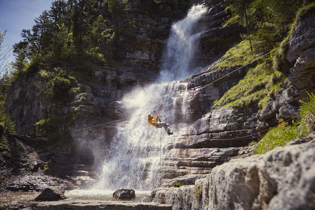 Man rappelling waterfall, Ehrwald, Tyrol, Austria — Stock Photo