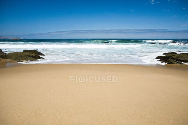 Пустой песчаный пляж с спокойной водой — стоковое фото