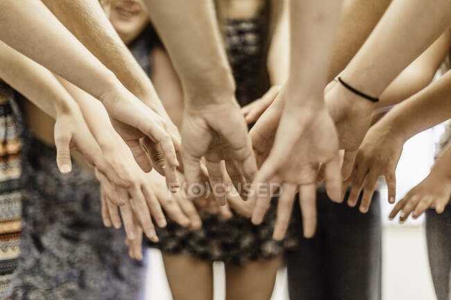 Close up of high school students dancing with hands together in dance class — Stock Photo