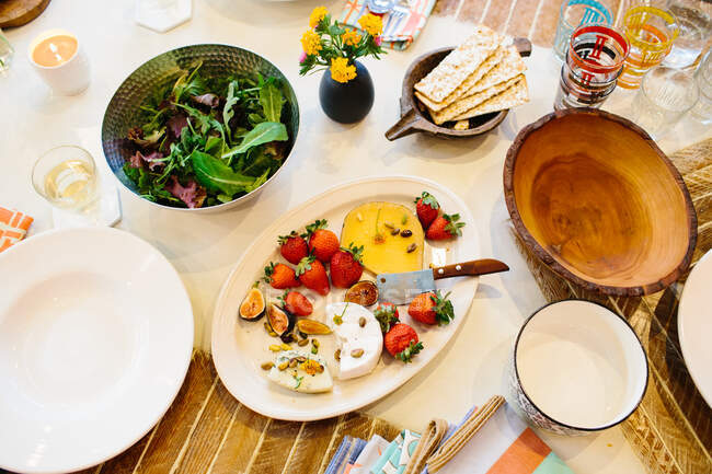 Prato de queijo, salada, biscoitos na mesa de jantar — Fotografia de Stock