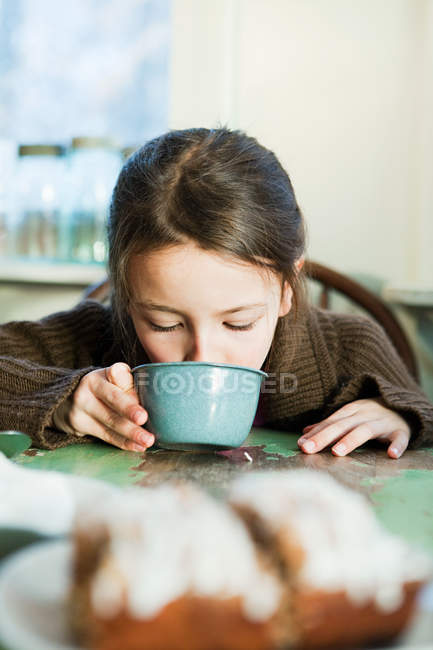 Young girl drinking hot drink — Stock Photo