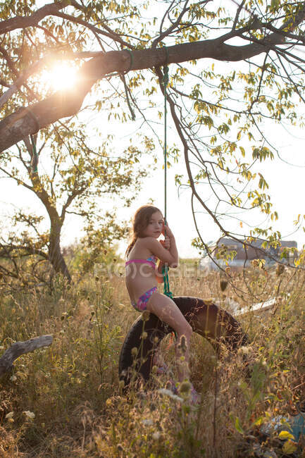 Girl on tire swing — Stock Photo