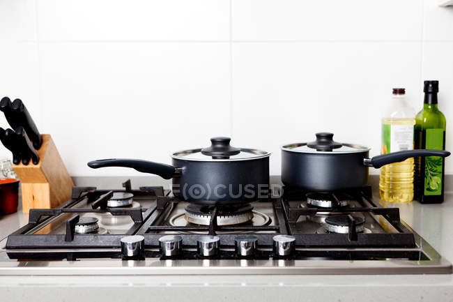 Saucepans on gas hob — Stock Photo
