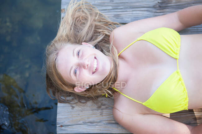 Girl lying on jetty — Stock Photo