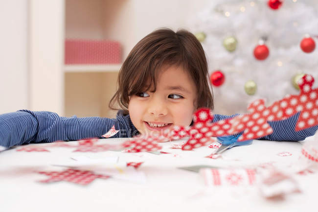 Girl holding Christmas decoration, smiling — Stock Photo