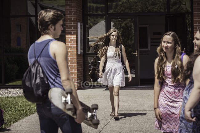 Studenti delle scuole superiori maschili e femminili che arrivano e lasciano la scuola superiore — Foto stock