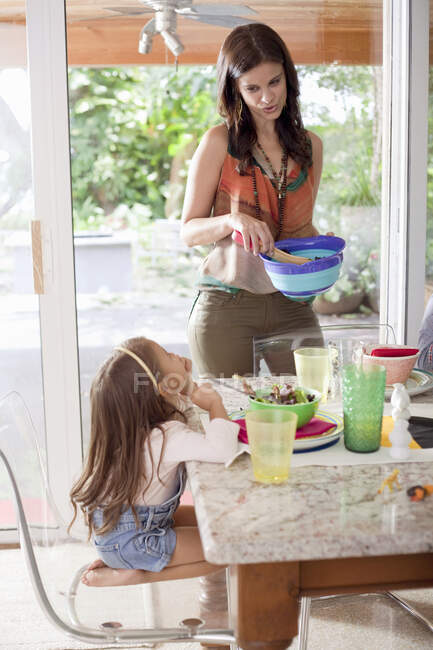 Mother serving daughter food — Stock Photo