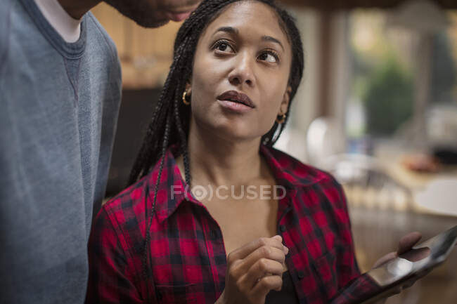 Cropped shot of mid adult couple using digital tablet in kitchen — Stock Photo