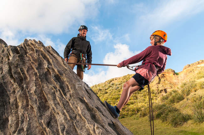 People abseiling in rock climbing lesson — Stock Photo