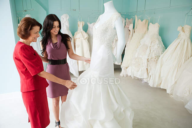 Мать и дочь смотрят свадебные платья — стоковое фото