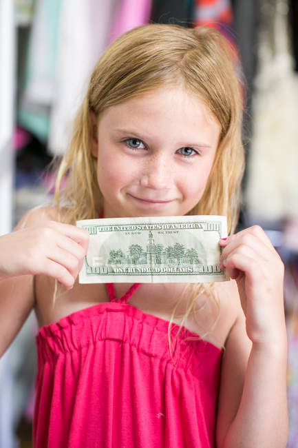 Portrait of girl holding dollar bill — Stock Photo
