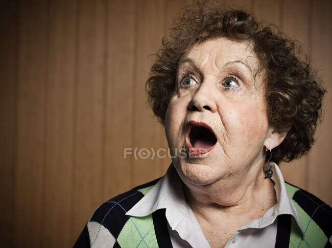 Studio portrait of shocked senior woman — Stock Photo