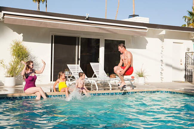 Family and outdoor swimming pool — Stock Photo