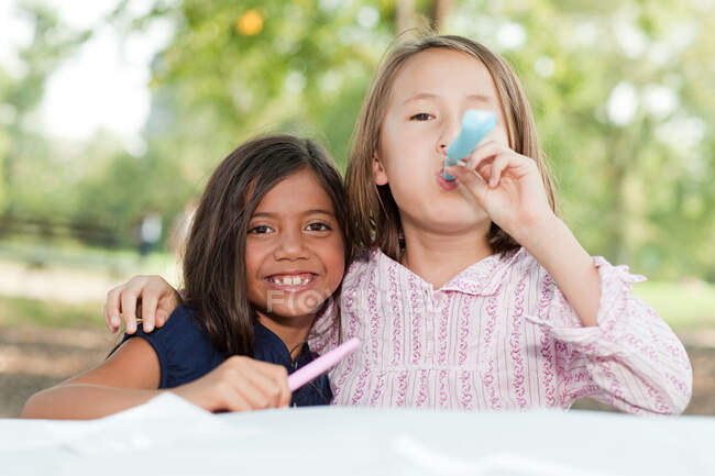 Girls at birthday party with party blowers — Stock Photo