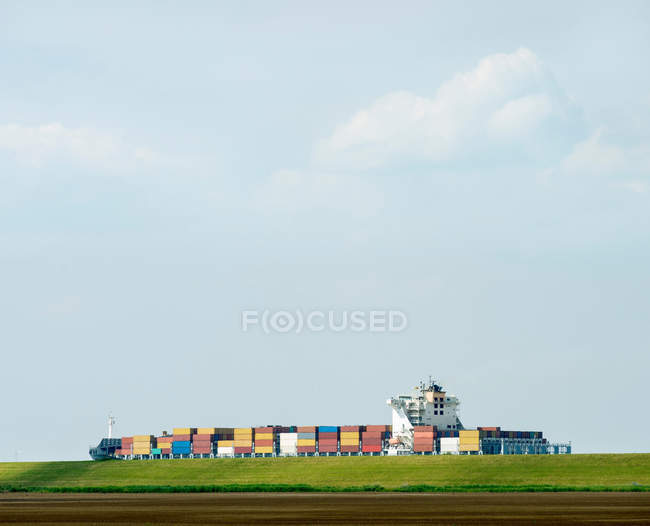 Containers in shipyard by rural field — Stock Photo