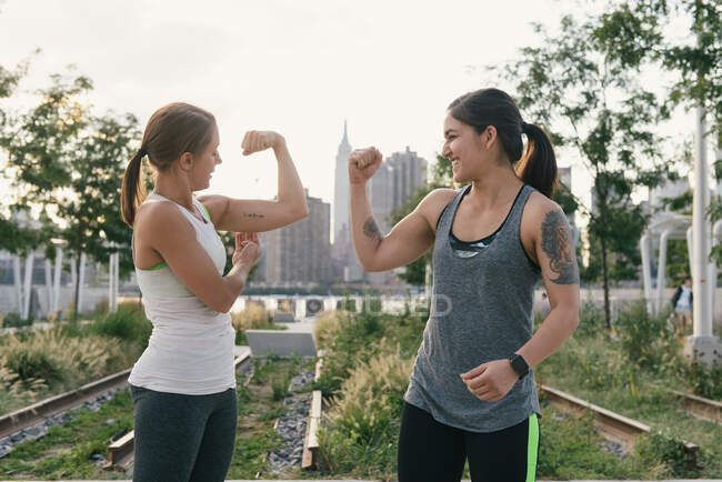 Two friends comparing bicep muscles — Stock Photo