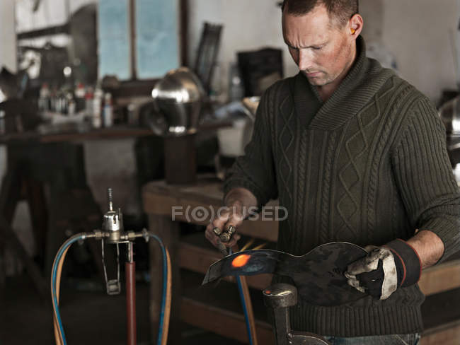 Blacksmith at work in shop, selective focus — Stock Photo