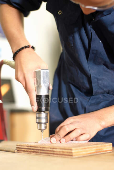 Worker using drill in factory — Stock Photo