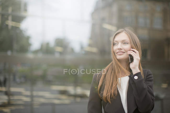 Businesswoman talking on smartphone, Freiburg, Germany — Stock Photo