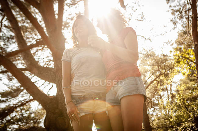Low angle view of mother and daughter enjoying nature in forest — Stock Photo