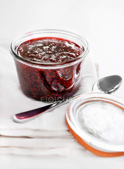 Pot of fruit jam with spoon, close up shot — Stock Photo