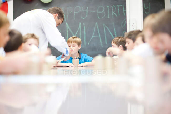 Boys making craft objects with supervisor — Stock Photo