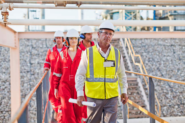 Workers walking at chemical plant — Stock Photo