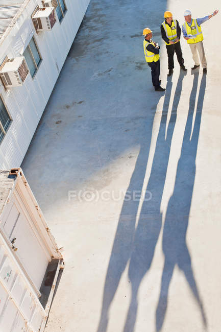 Workers casting shadows on site — Stock Photo