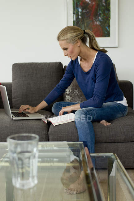 Mature woman working from home on laptop — Stock Photo